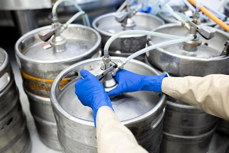 A Man Working On Keg Container's nozzle